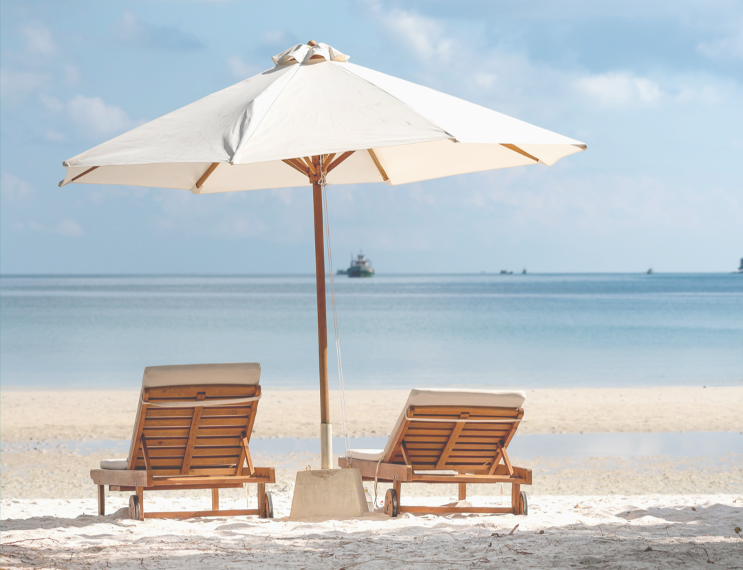 Two Brown Wooden Armchairs Beside Umbrella Near Seashore