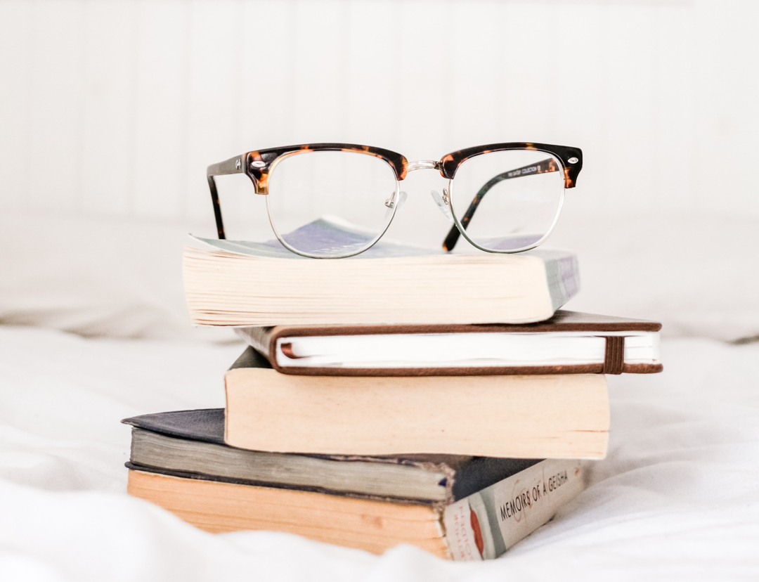 Pair of Glasses On Pile of Books